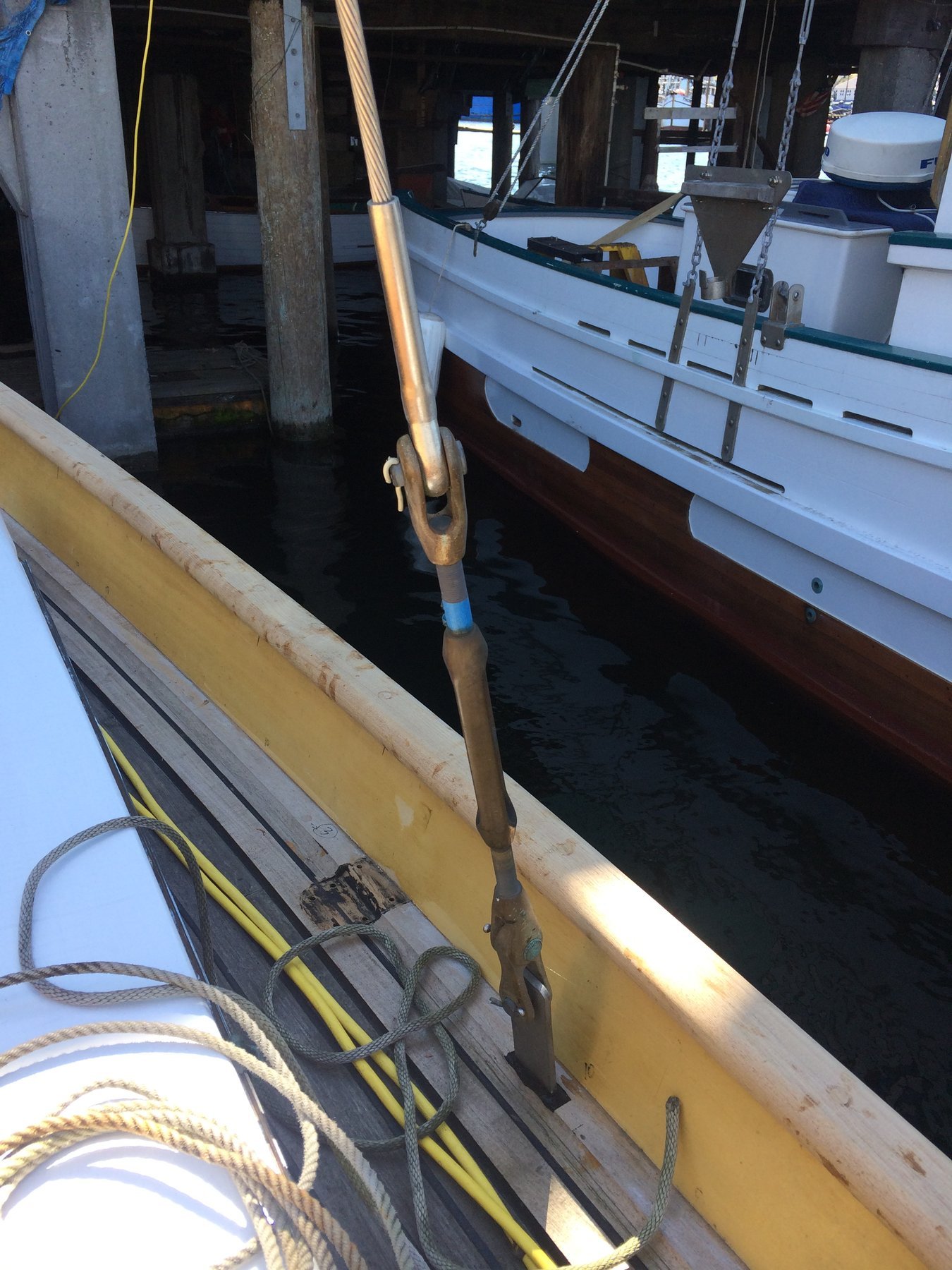 Merry Maiden's wooden boom and rigging detail, showcasing the classic craftsmanship of this 1946 Philip Rhodes design during restoration work in Puget Sound.