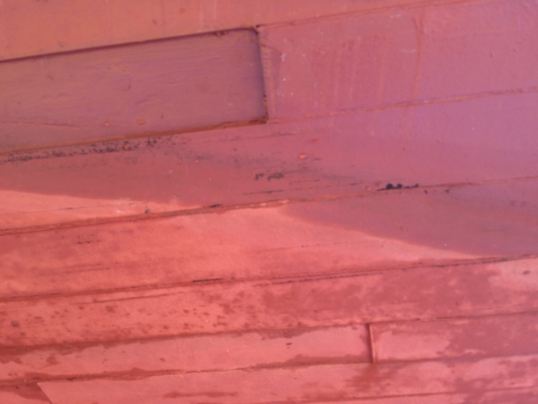 The weathered deck of the classic 1946 Philip Rhodes-designed Merry Maiden reveals layers of patina and salt spray, telling the story of decades spent sailing Puget Sound's cool waters.