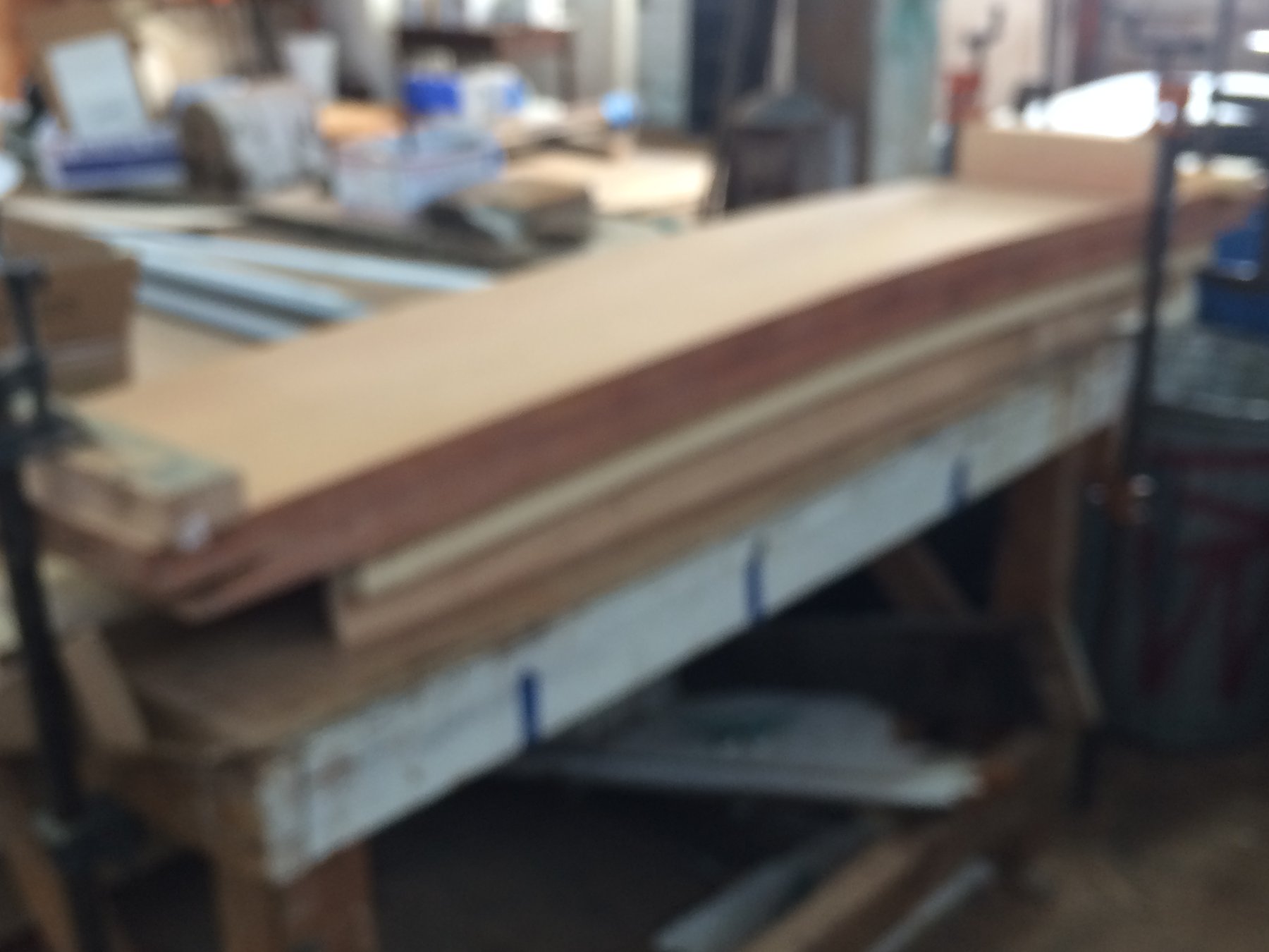 The classic wooden hull of Merry Maiden, a 1946 Philip Rhodes design, reveals her timeless craftsmanship with gleaming varnish and traditional construction details in the boatyard.