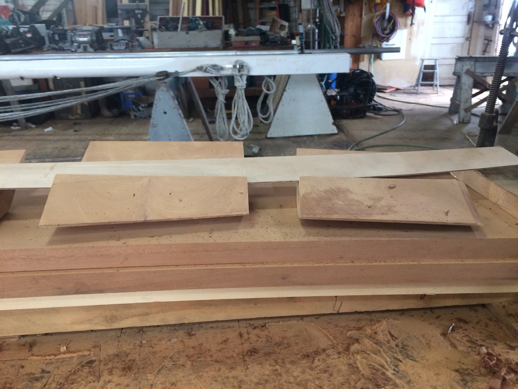 Restoration work on Merry Maiden's classic wooden hull reveals the careful craftsmanship required to preserve this 1946 Philip Rhodes design, with precision-cut timber components awaiting installation in the boatyard.