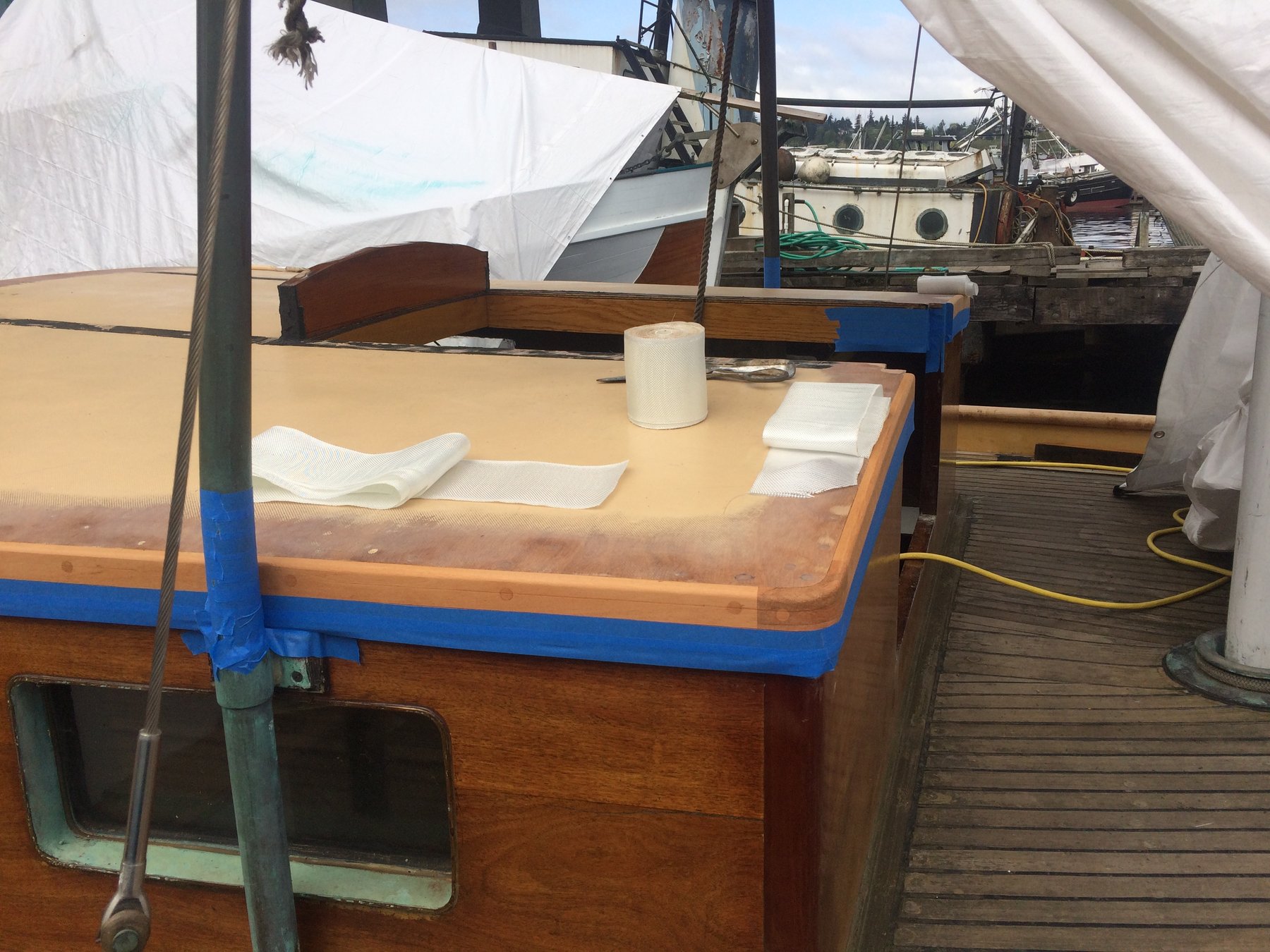 The elegant cabin sole of the classic 1946 Philip Rhodes yacht Merry Maiden, with her traditional wood and blue trim visible during restoration work at a Puget Sound mooring.