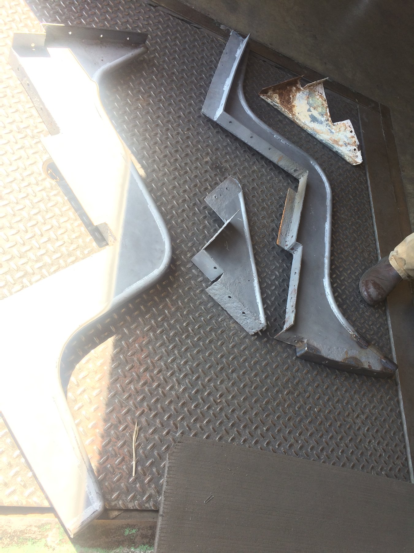 Vintage hardware and metal fittings rest on the diamond-plate deck of the classic 1946 Philip Rhodes-designed Merry Maiden, showing the weathered patina of decades of Pacific Northwest sailing.