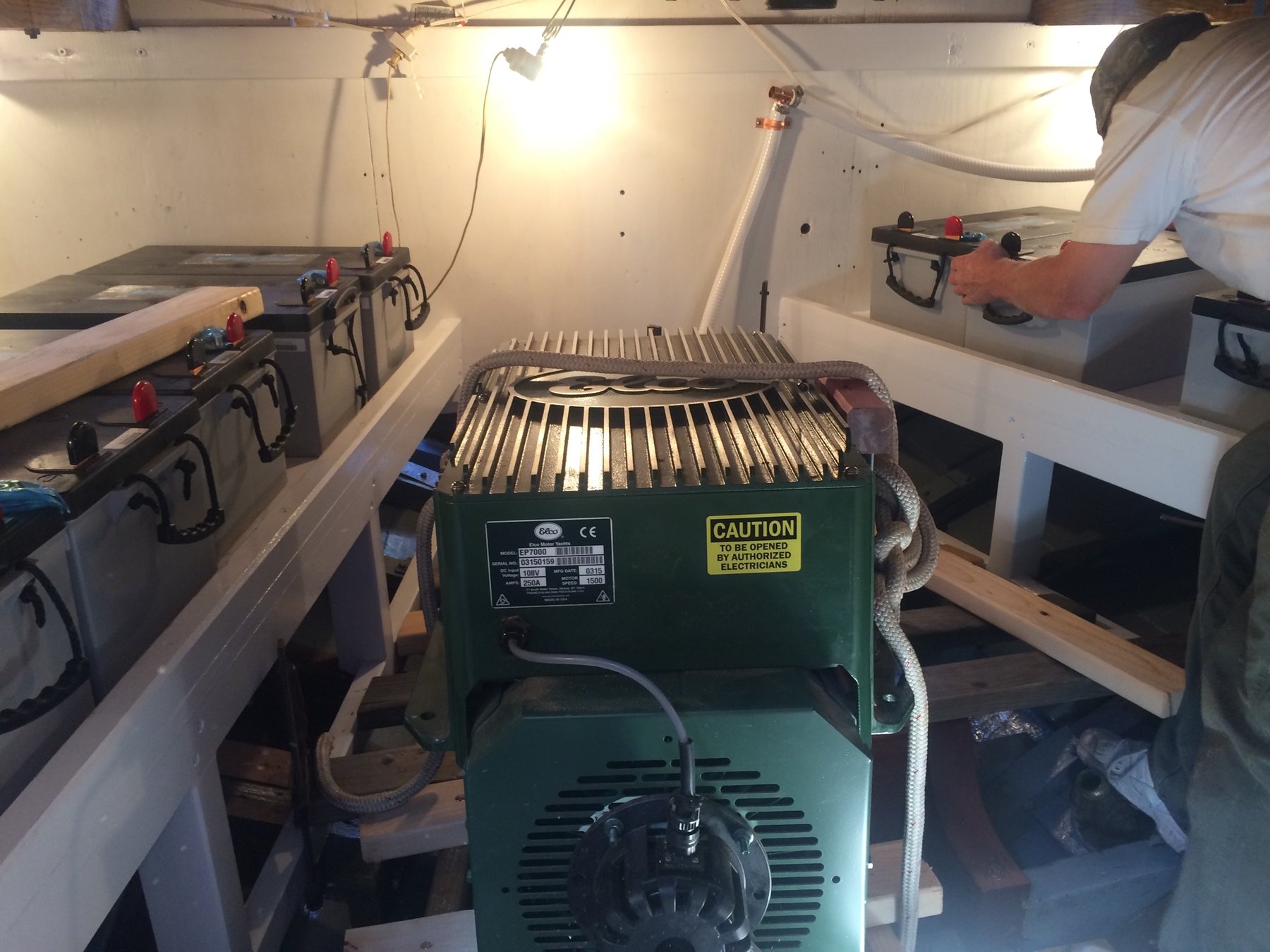 The engine room of Merry Maiden reveals the meticulous restoration work on this 1946 classic yacht, with a green electric motor built by Elco.