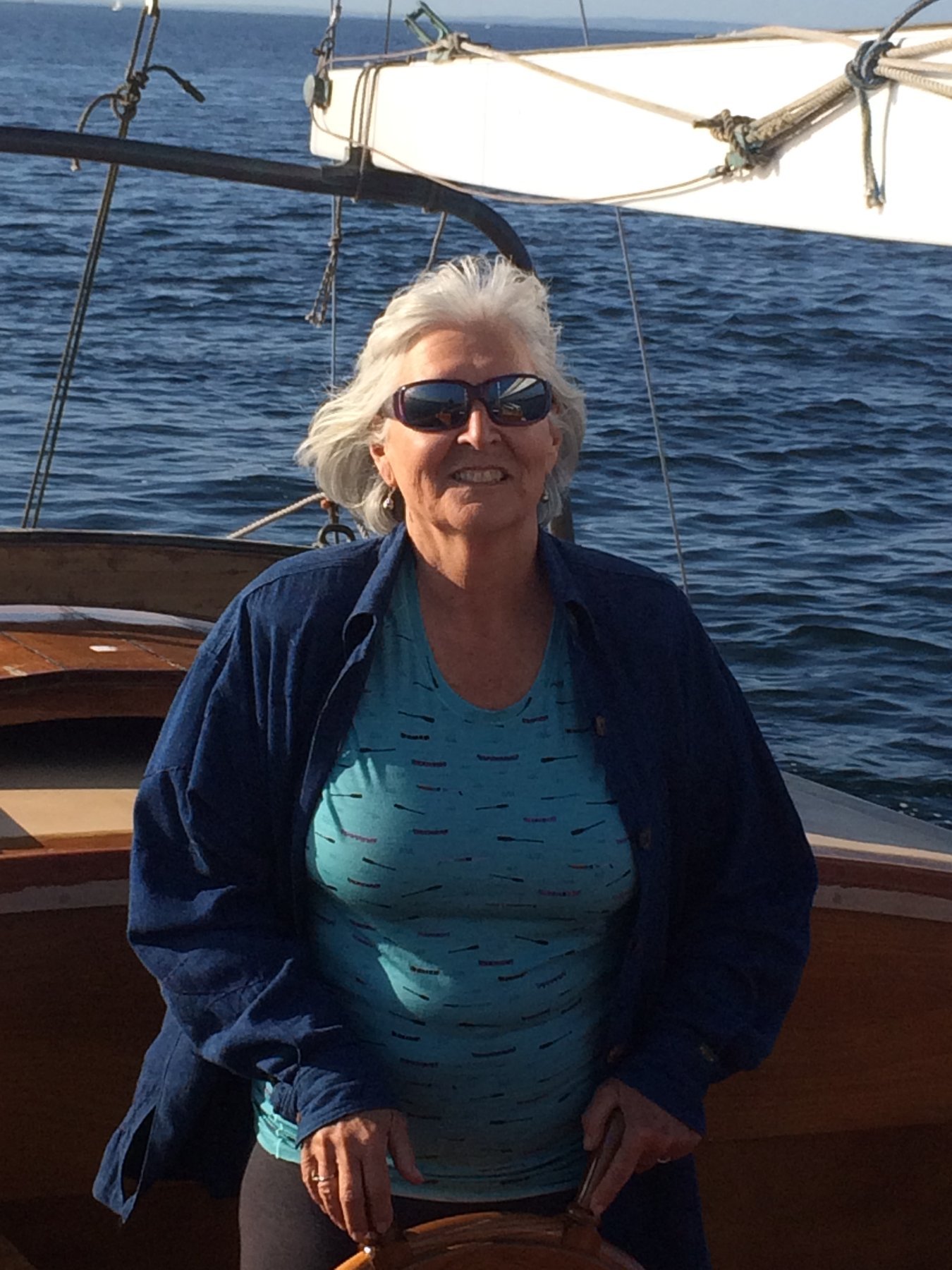 A sailor enjoys the gentle waters of Puget Sound aboard the classic 1946 Merry Maiden, her traditional lines and rigging a testament to timeless yacht design.