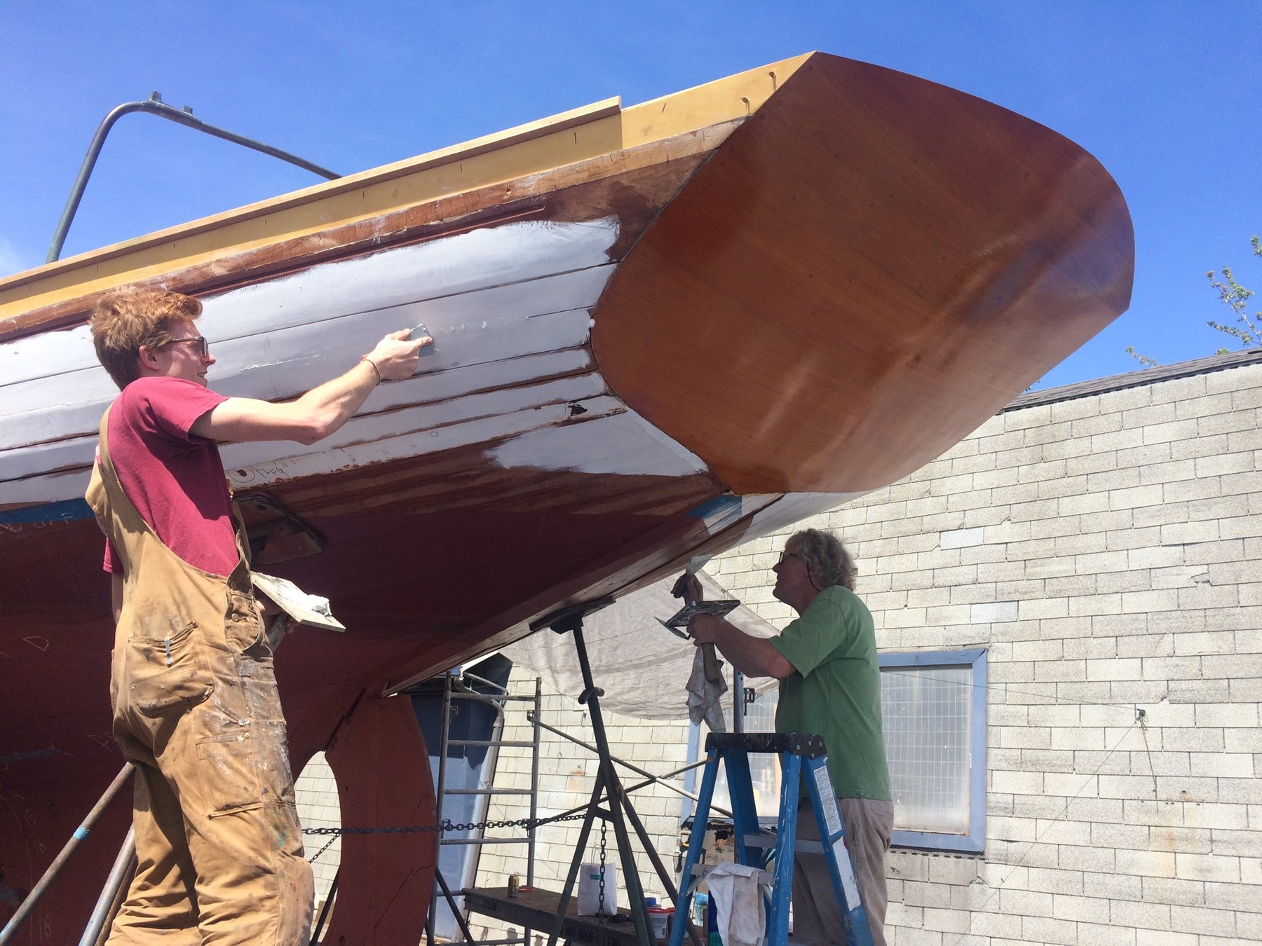 Craftsmen carefully restore the Merry Maiden's classic wooden hull, revealing the meticulous care required to preserve a 1946 Philip Rhodes masterpiece.